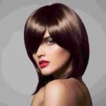 Glamorous long brunette hair with voluminous soft curls and glossy blowout at HOB Salon