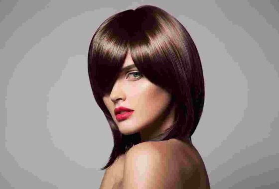 Glamorous long brunette hair with voluminous soft curls and glossy blowout at HOB Salon